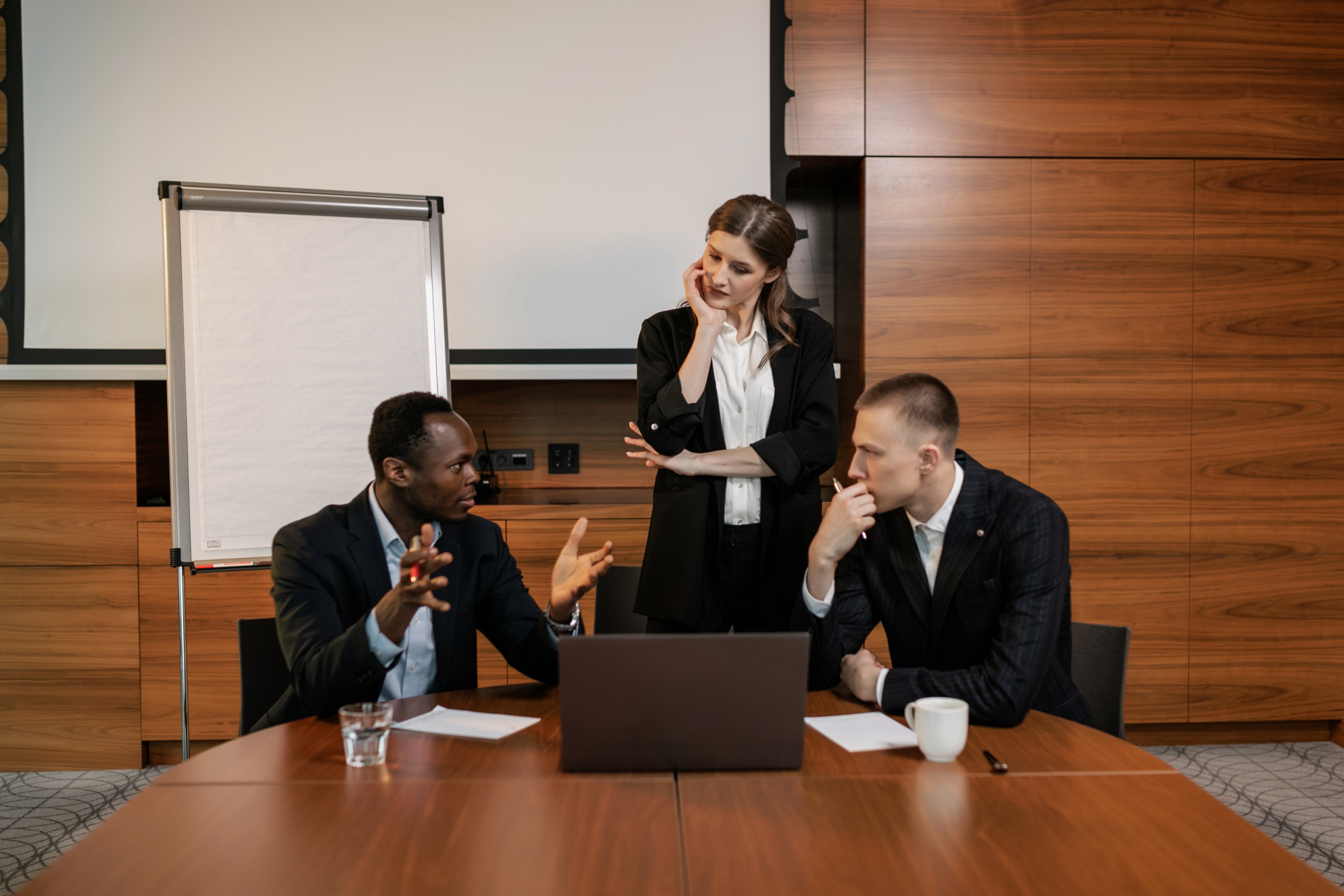 Photo by Alena Darmel: https://www.pexels.com/photo/men-in-black-suit-jacket-sitting-beside-woman-in-black-blazer-standing-8134001/